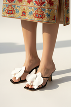 Model legs wearing black floral heels