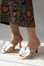 Model legs wearing floral heels